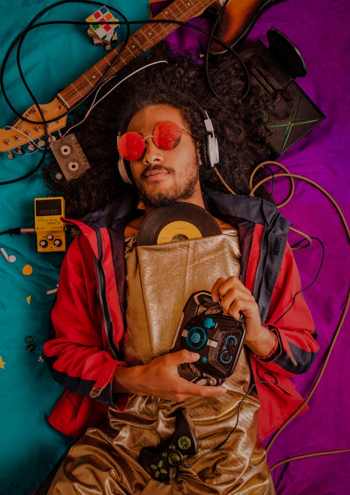 pexels-photo-3756766 Man with afro and headphones enjoying retro music surrounded by vintage items.